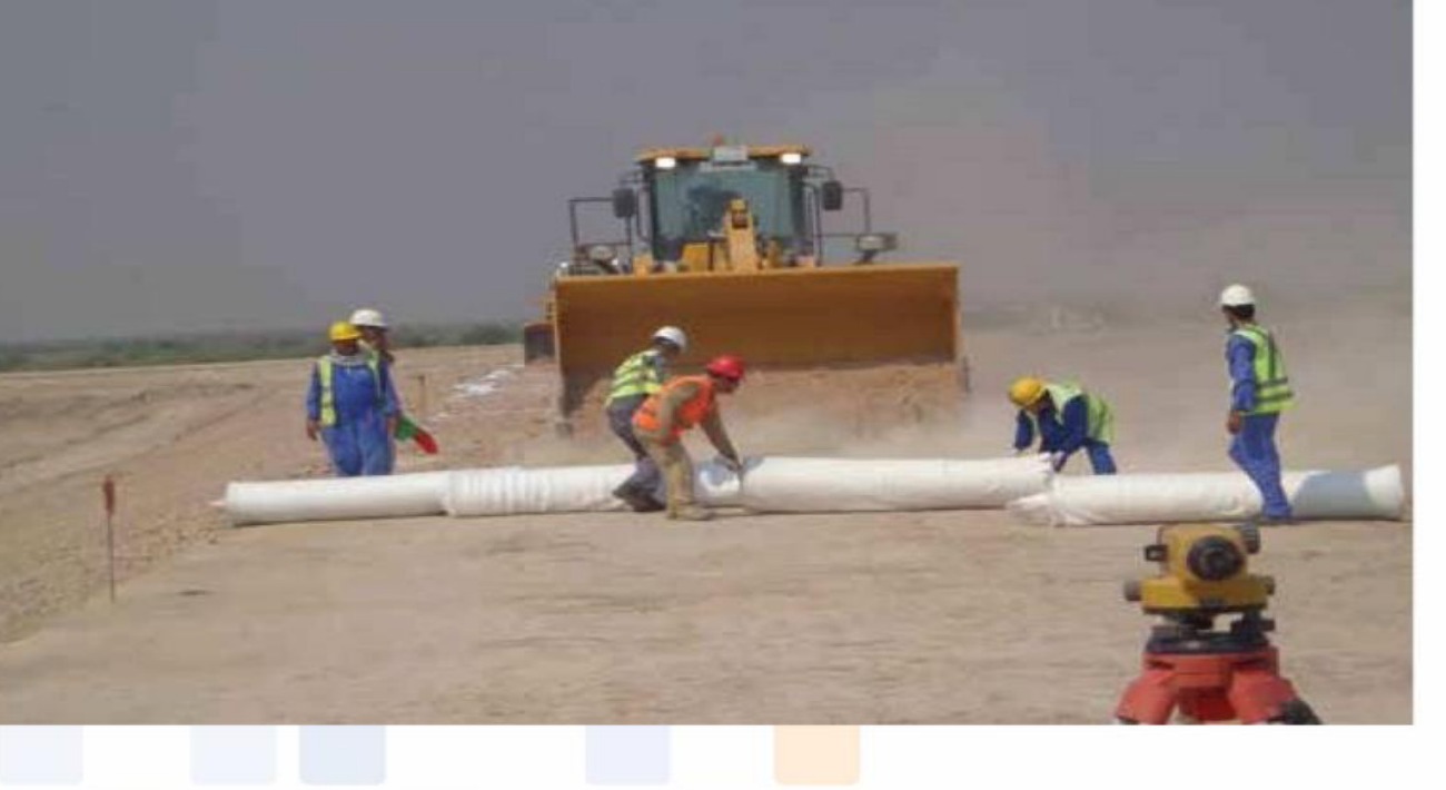 LAHAI pipeline and geotextile installation — workers and bulldozer laying pipeline on oil field